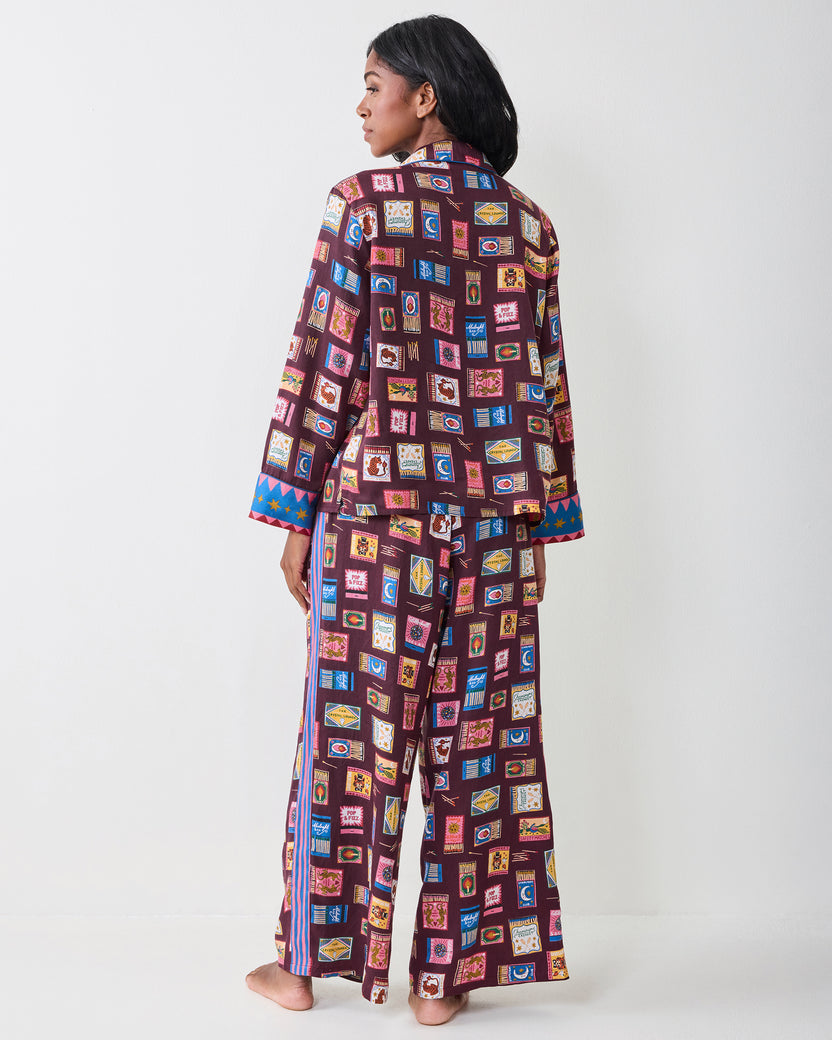 Back view of the Cabernet Painted Matchbook pajama set showing the printed button-front top, matching wide-leg pants, and contrasting side stripes.