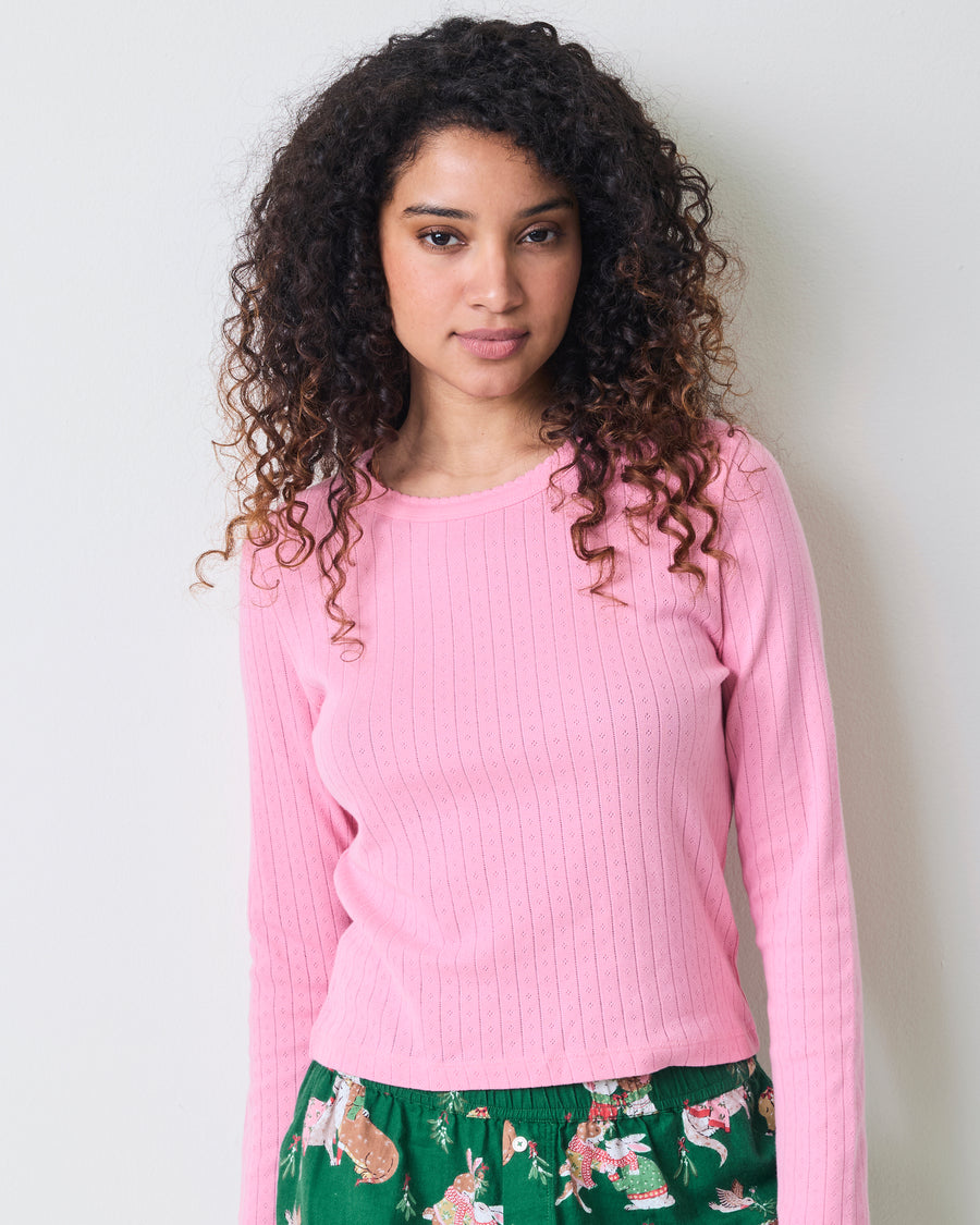Close front view highlighting the pink taffy pointelle texture and scalloped neckline of the long-sleeve top.
