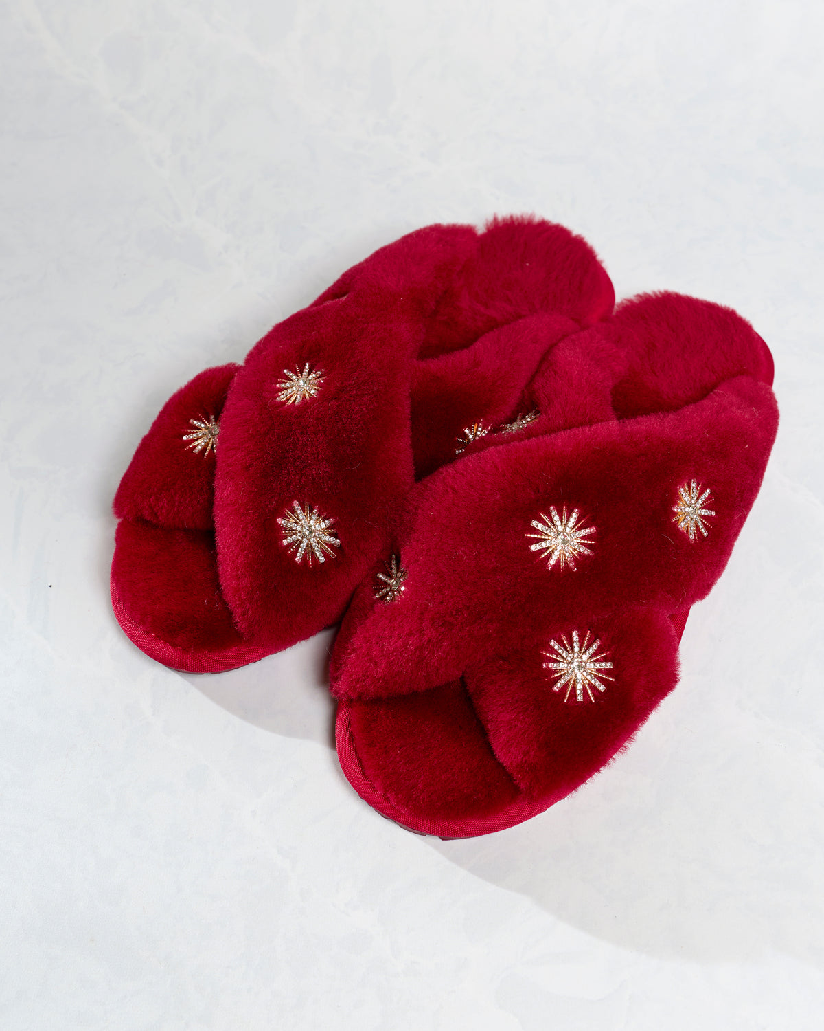 Wine sheepskin slippers with rhinestone embellishments, shown together from above.