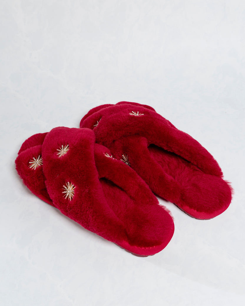 Wine sheepskin slippers with rhinestone embellishments, shown from a low side angle.
