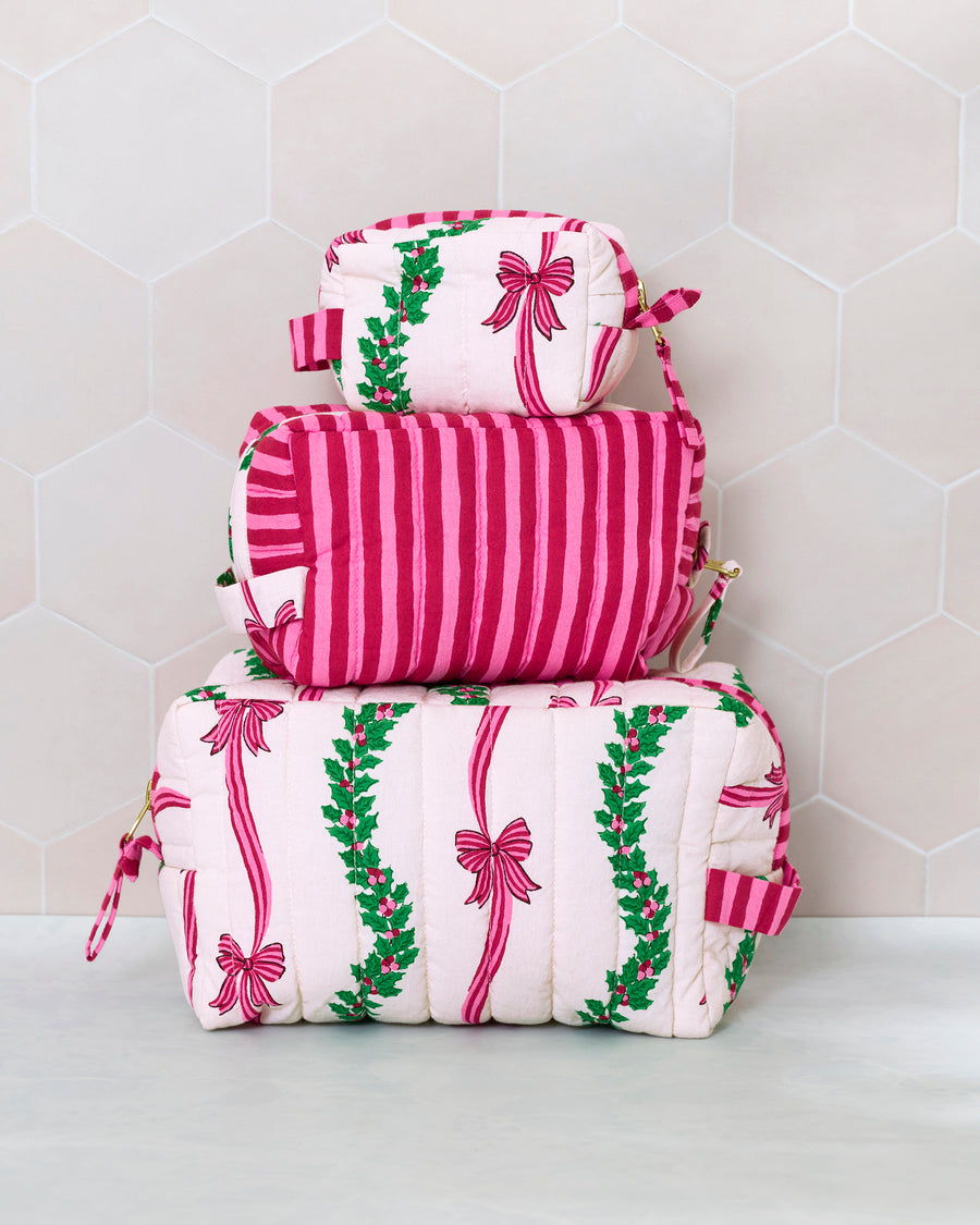 Three quilted pouches stacked by size, showing the Ribbons & Bows print and a shoulder strap.
