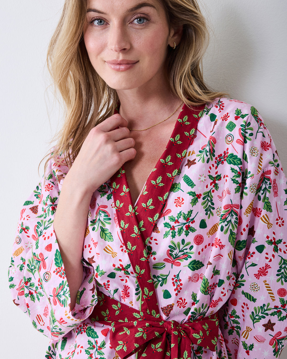 Close front view of the Sweet Tooth Getting Ready Robe in Candy Pink, showing the printed wrap front, red trim, and tied belt.