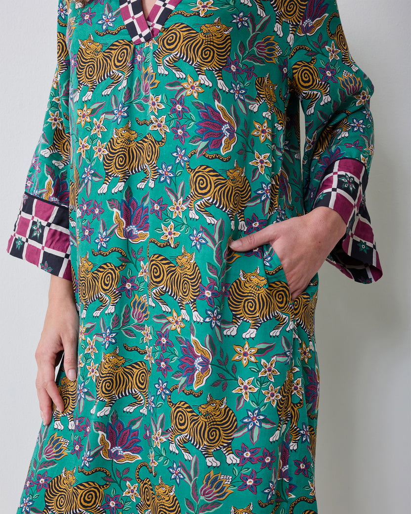 Close view of the Royal Teal Tibetan Tigress caftan showing its tiger-and-floral print, contrasting trim, and sleeve cuff.