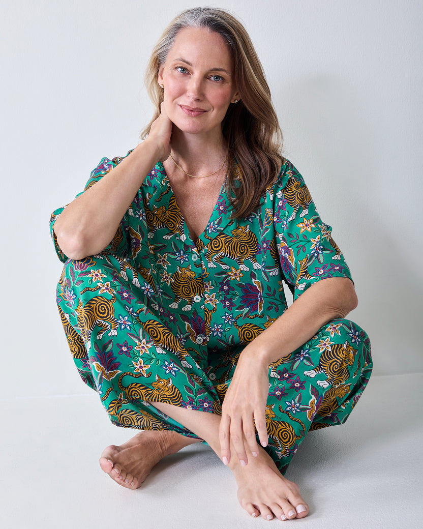 Seated view of the Royal Teal Wildest Dreams shirt and wide-leg pants set, showing the button-front shirt and tiger-and-floral print.