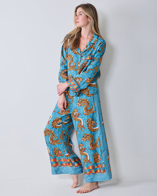 Full view of a model wearing the Persian Turquoise Twisted Tiger pajama set with a collared top, wide-leg pants, and patterned hems.