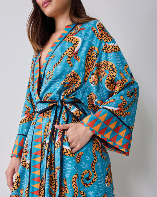 Close view of a turquoise tiger-print satin robe tied at the waist.
