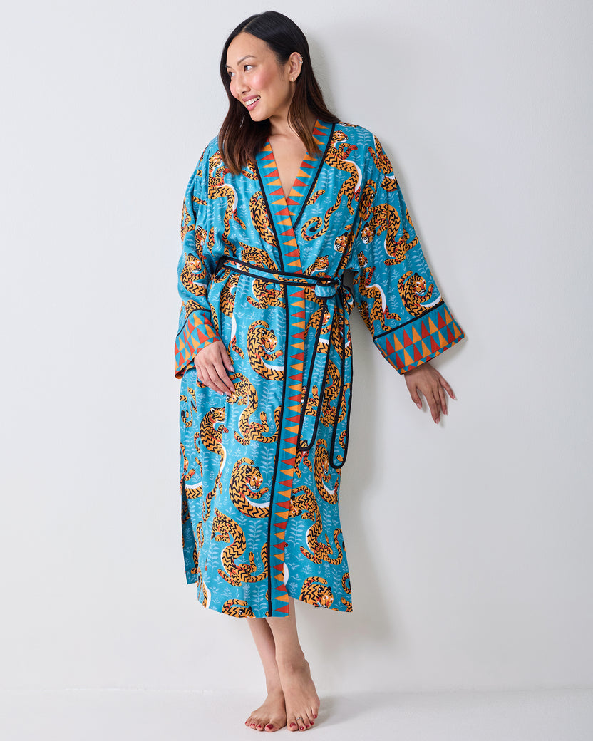 Full-length front view of a model wearing a turquoise tiger-print robe with a waist tie.