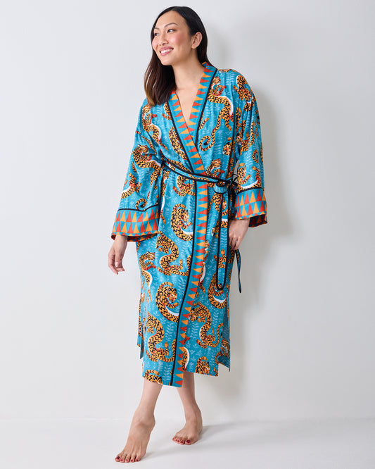 Three-quarter front view of a model wearing a turquoise tiger-print robe with a waist tie.