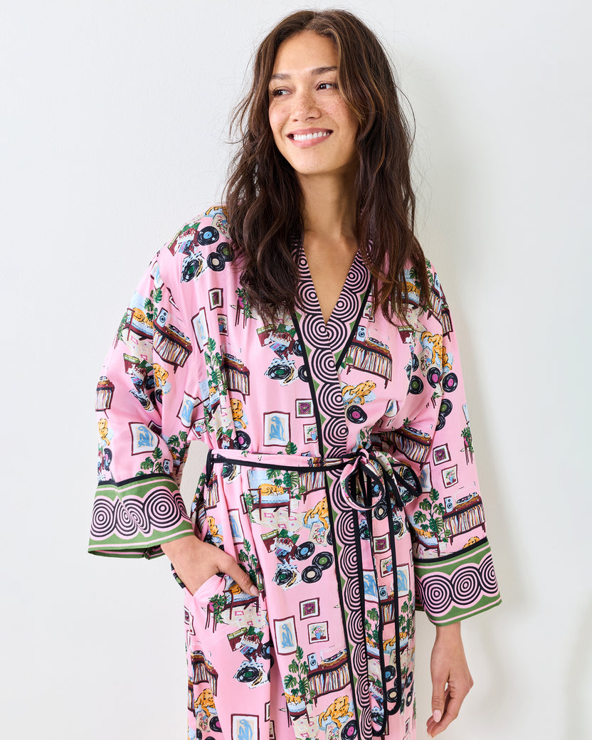 Close view of the pink Vinyl Collector robe showing its patterned collar, matching belt, and printed design.