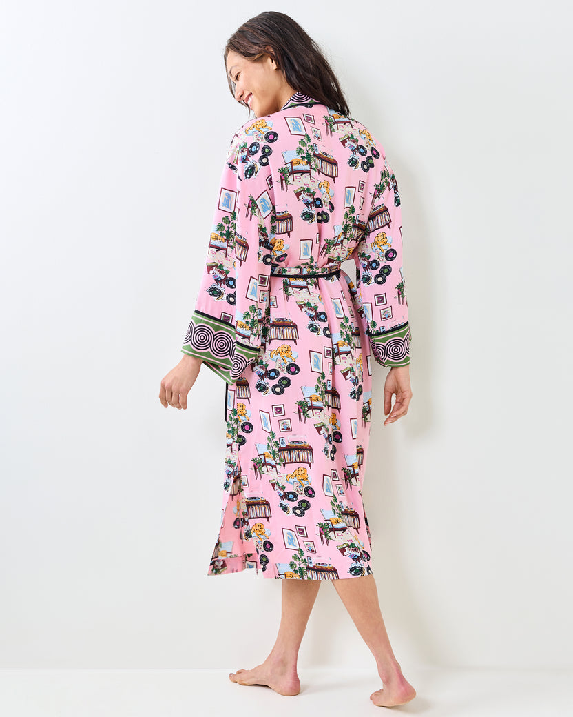 Back view of the pink Vinyl Collector satin robe with a belted waist, patterned print, and contrasting cuff trim.