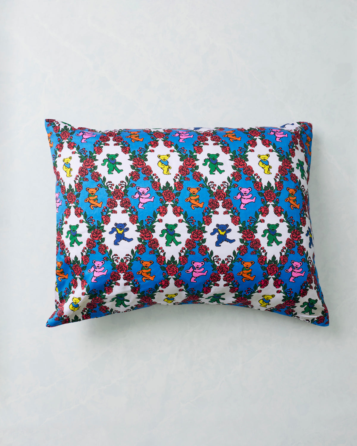 Full view of the Wandering Rose pillowcase with repeating colorful dancing bears and red rose garlands.