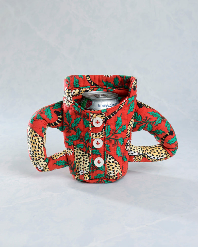 Front view of the Winter Holly Bagheera quilted pajama cozie around a beverage can, with three buttons and two side handles.