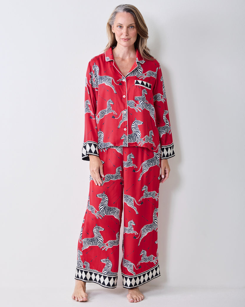 Front view of a person wearing the red zebra-print Soho pajama set with geometric trim.
