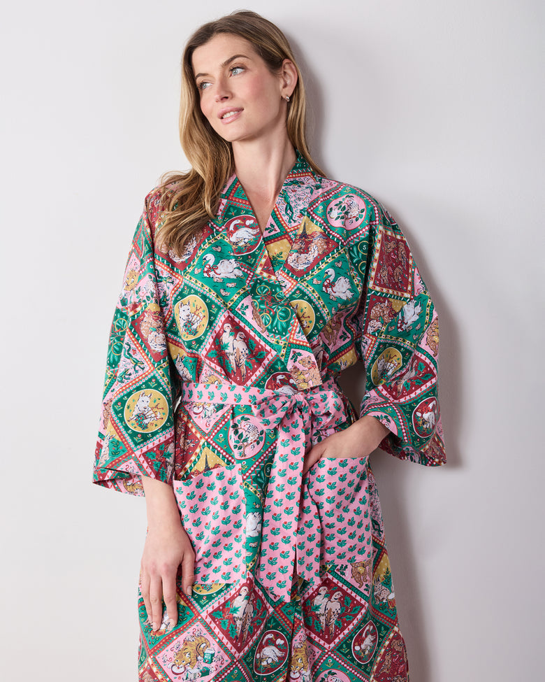 Front view of a person wearing the printed long robe with a tied sash and front pockets.