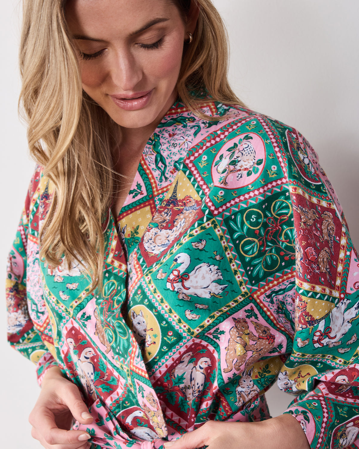 Close-up of the printed robe showing holiday illustration panels and the overlapping front neckline.