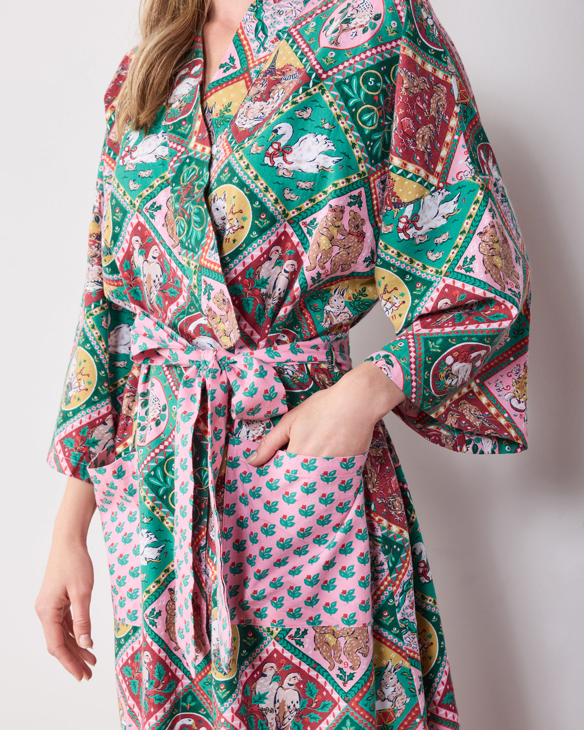 Close view of a patterned long robe with a waist tie and patch pockets.