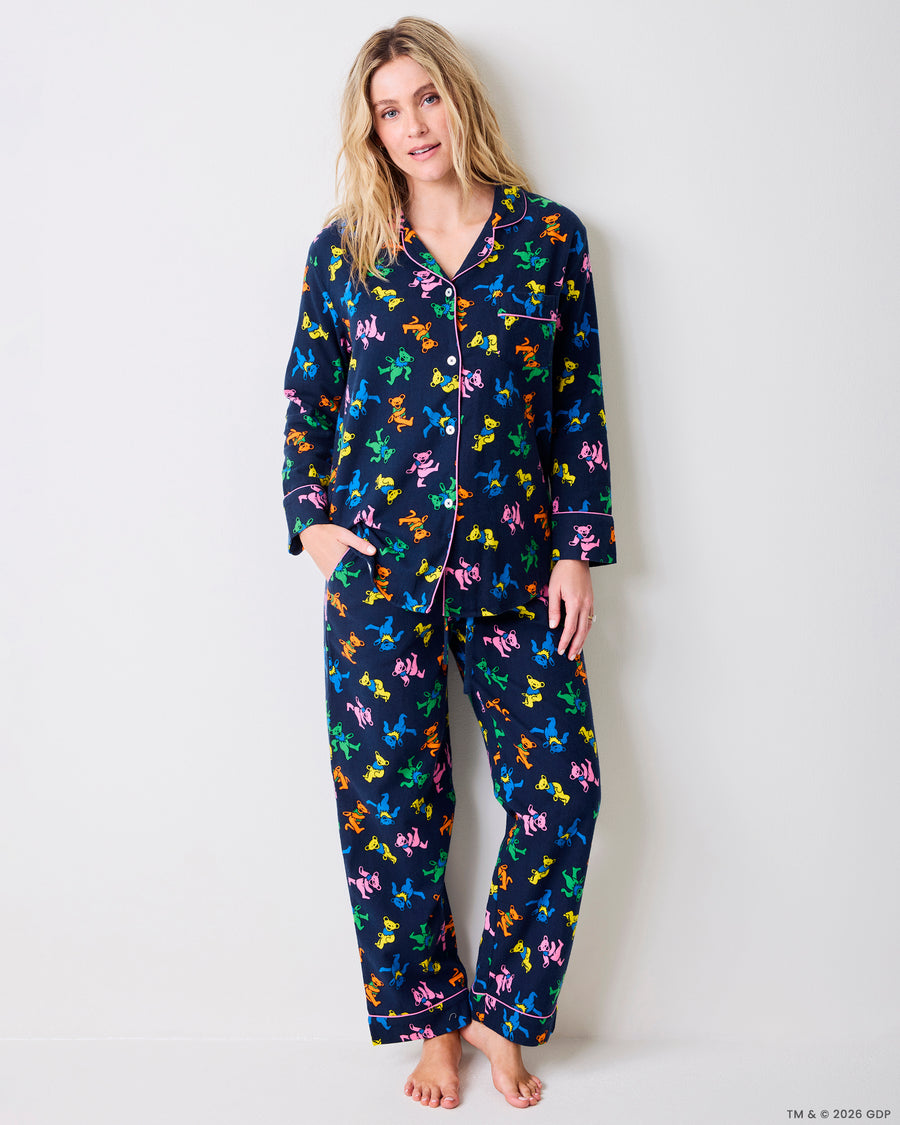 Full-length view of a navy Dancing Bears pajama set with colorful bear prints, button-front shirt, and straight-leg pants.