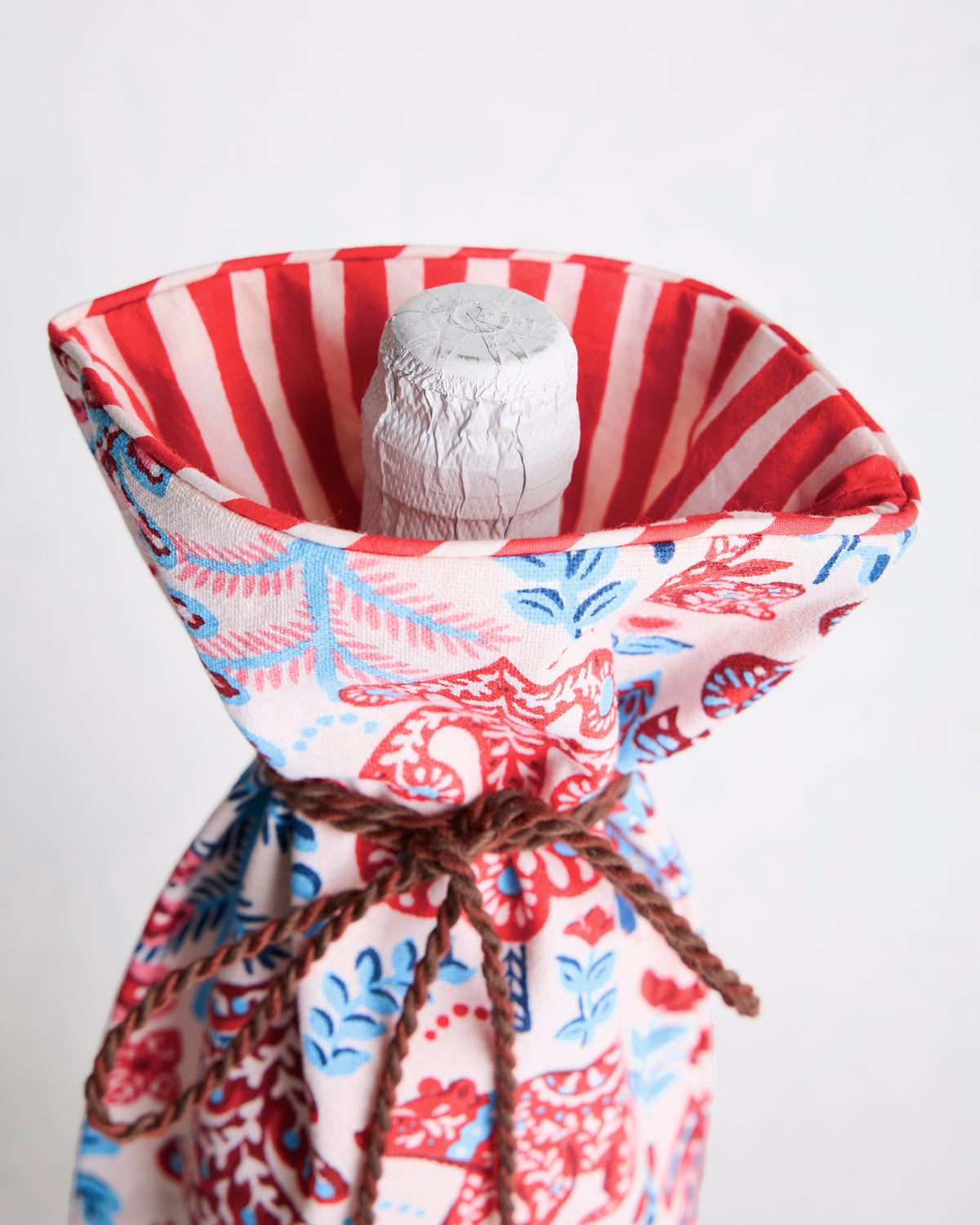 Open wine bag showing its red-and-white striped lining and the top of a bottle inside.