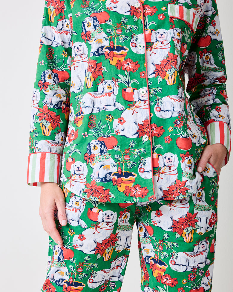 Close-up of the Good Dog Christmas evergreen tall long pajama set showing the button-front top, chest pocket, dog-and-holiday print, and striped cuffs.