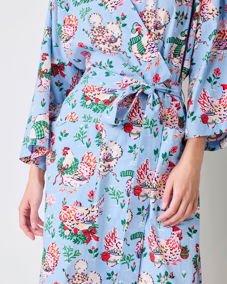 Close view of the pale blue Holiday Hens long robe showing its tie belt, side pockets, and chickens wearing winter hats and scarves.