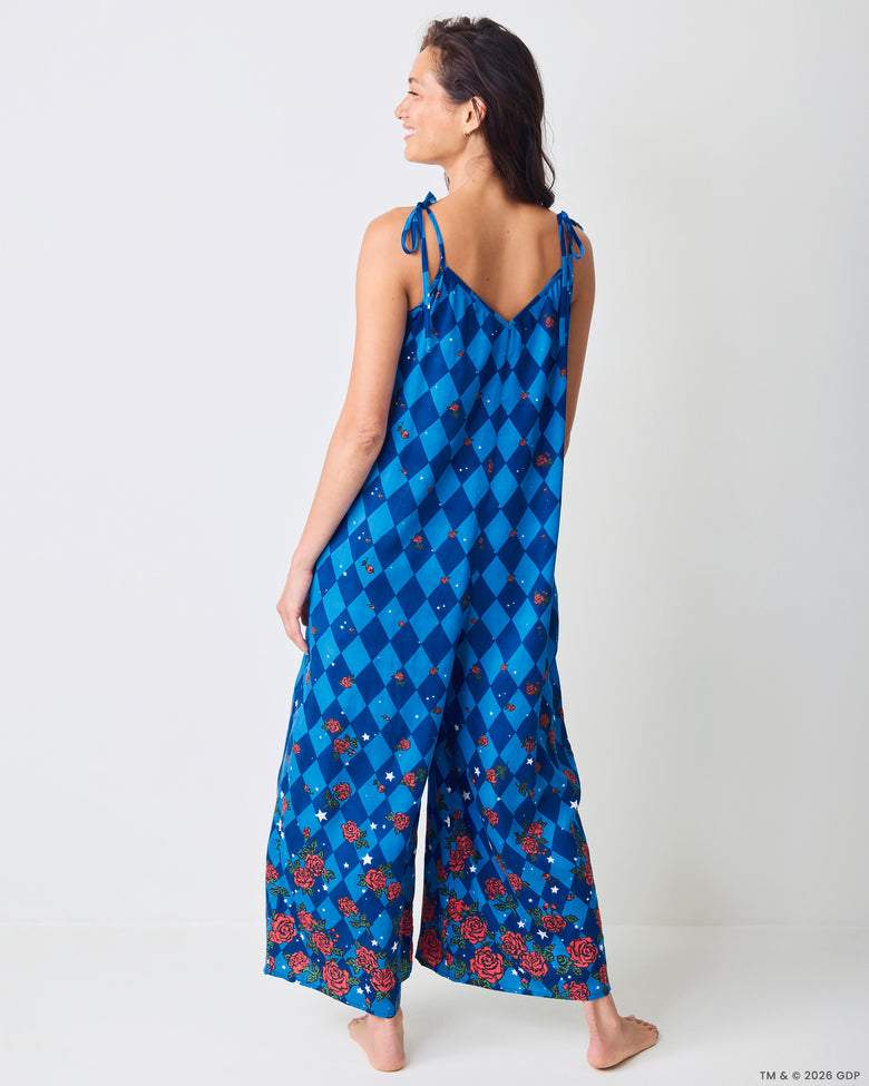 Back view of the blue argyle-print Jaipur jumpsuit with tied shoulder straps and rose and star motifs.