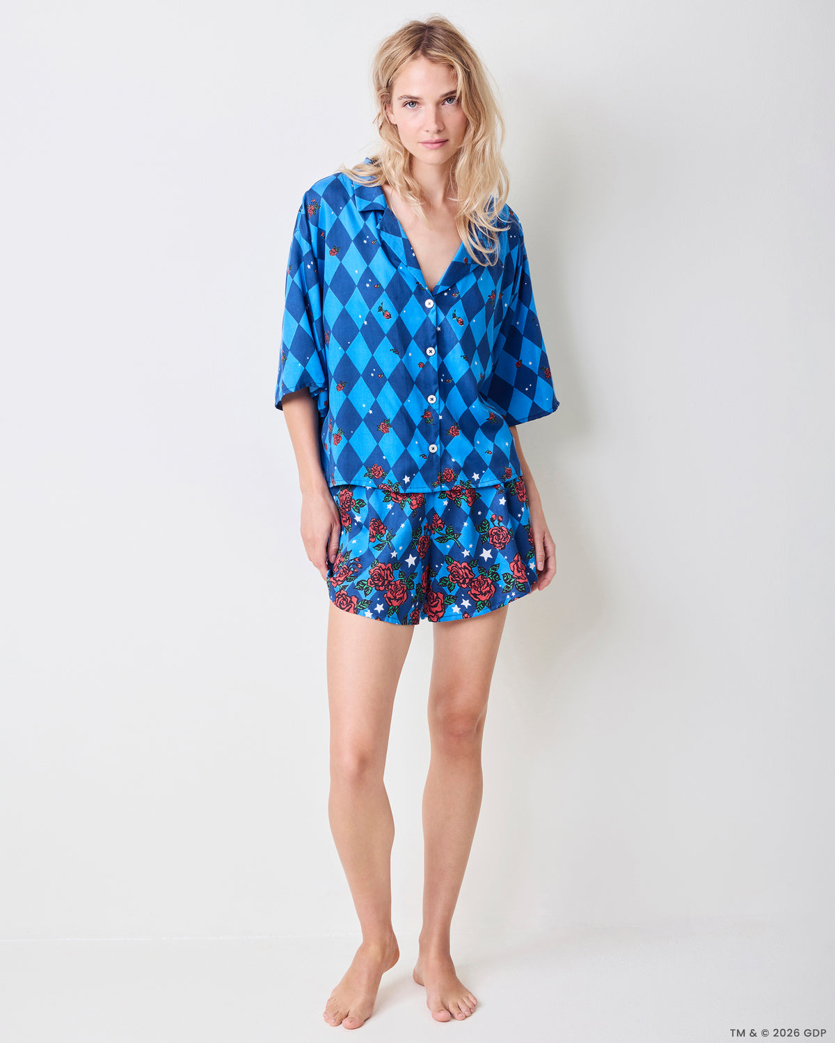 Front view of the blue patterned Sweet Dreams Set with a button-front top and matching rose-and-star print shorts.
