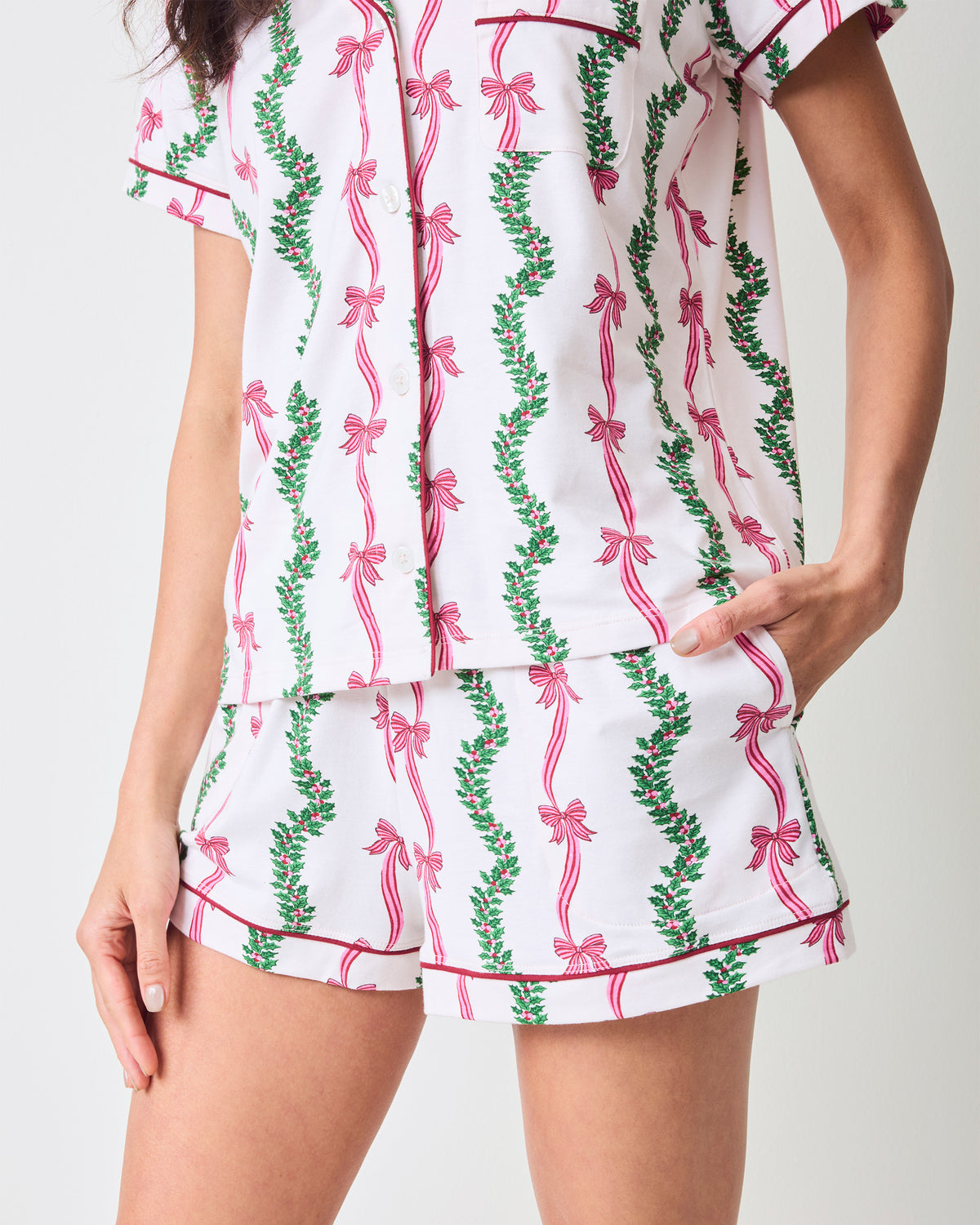 Close-up of the Ribbons & Bows Vanilla Cream short pajama set showing the button-down top, pocket, and matching shorts.