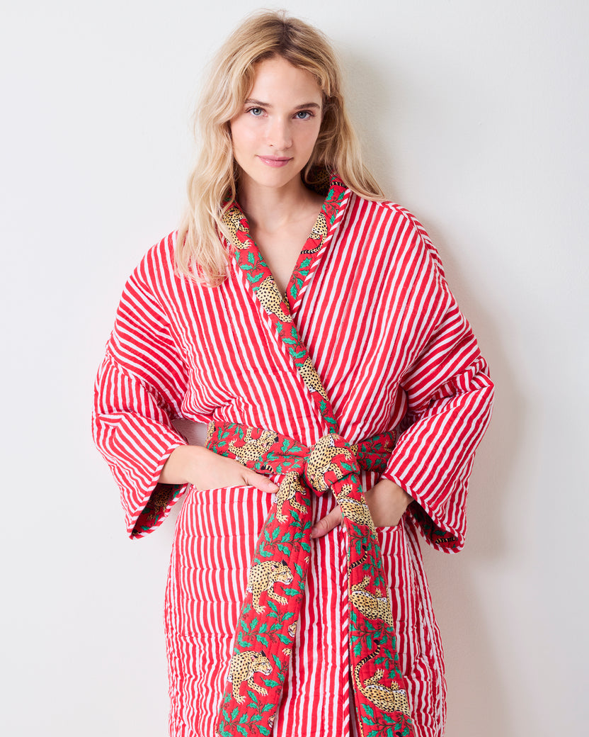 Front view of the striped side of a reversible quilted robe, with leopard-print trim and matching belt.