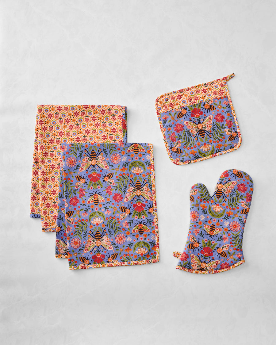 Bee Tapestry kitchen bundle with two tea towels, a pot holder, and an oven mitt, shown flat.