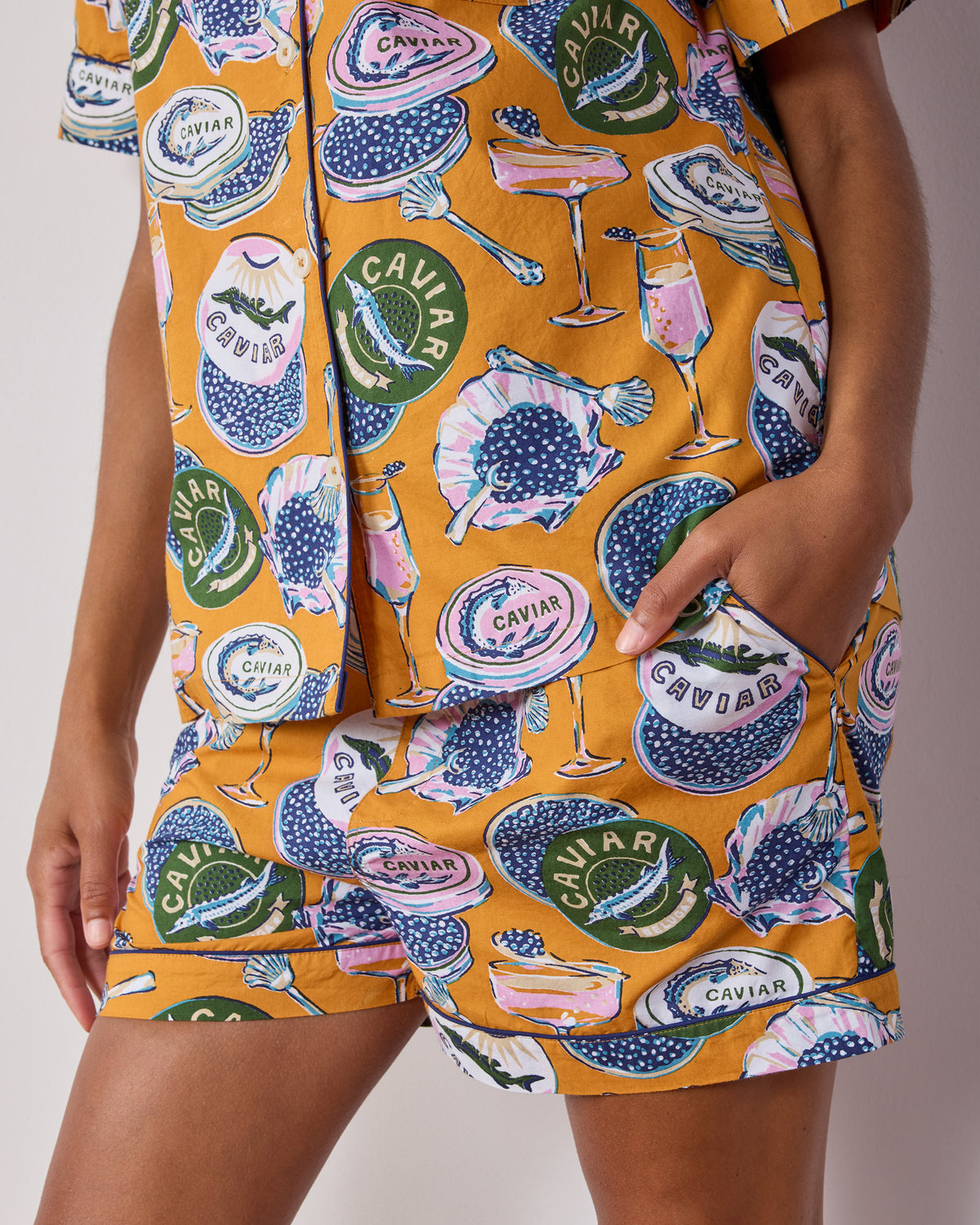 Close-up of the matching pajama shorts showing the printed caviar motif, elastic waistband, drawstring, and side pocket.