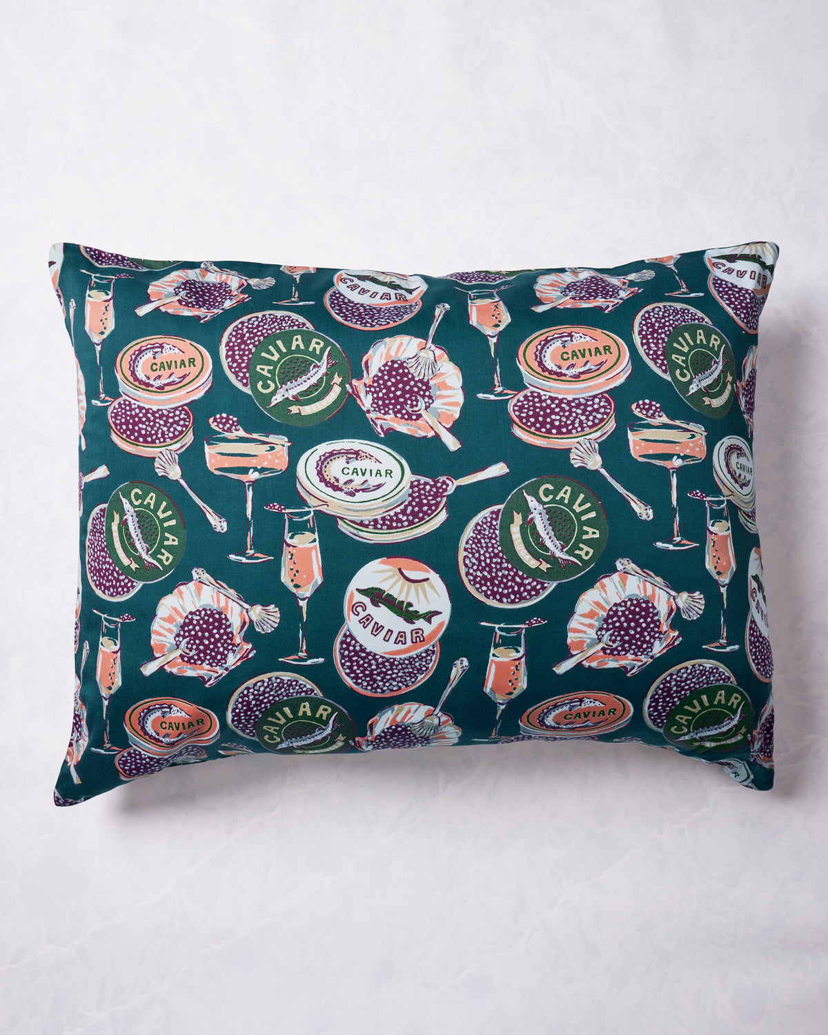 Peacock Feather Eco Satin pillowcase shown flat, covered in a Champagne & Caviar print of caviar tins, champagne glasses, spoons, and fish.