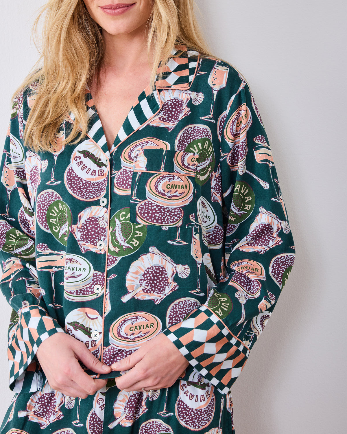 Close-up of the Champagne & Caviar Soho pajama top showing the collar, chest pocket, buttons, and contrasting geometric cuffs.