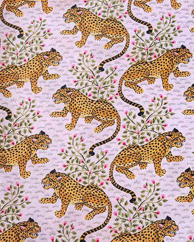 Light pink patterned swatch with repeated orange spotted big cats, leafy branches, and pink flowers