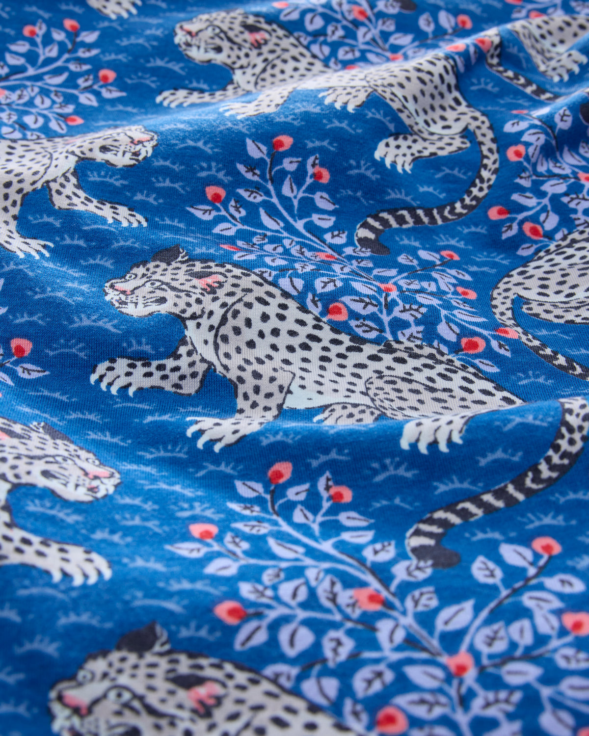 Close-up of the indigo Bagheera print with spotted cats and leafy branches