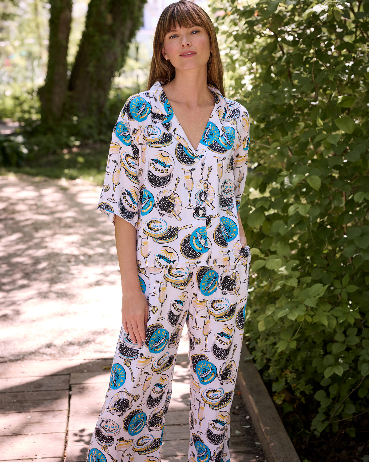 Full view of the Pearl Champagne & Caviar Wildest Dreams pajama set with a relaxed short-sleeved top, wide-leg pants, and pockets.