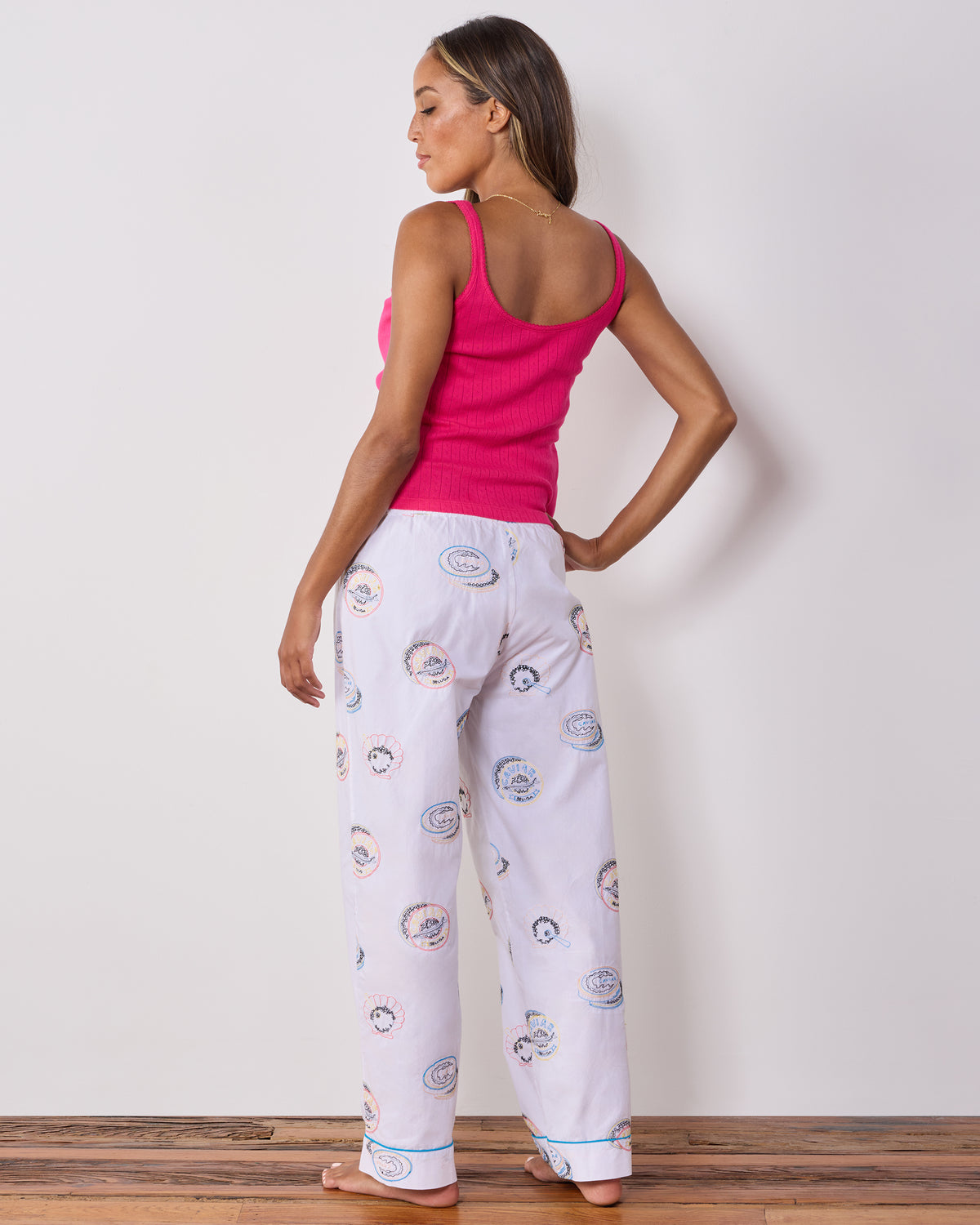 Back view of pearl pajama pants with embroidered caviar tin motifs.