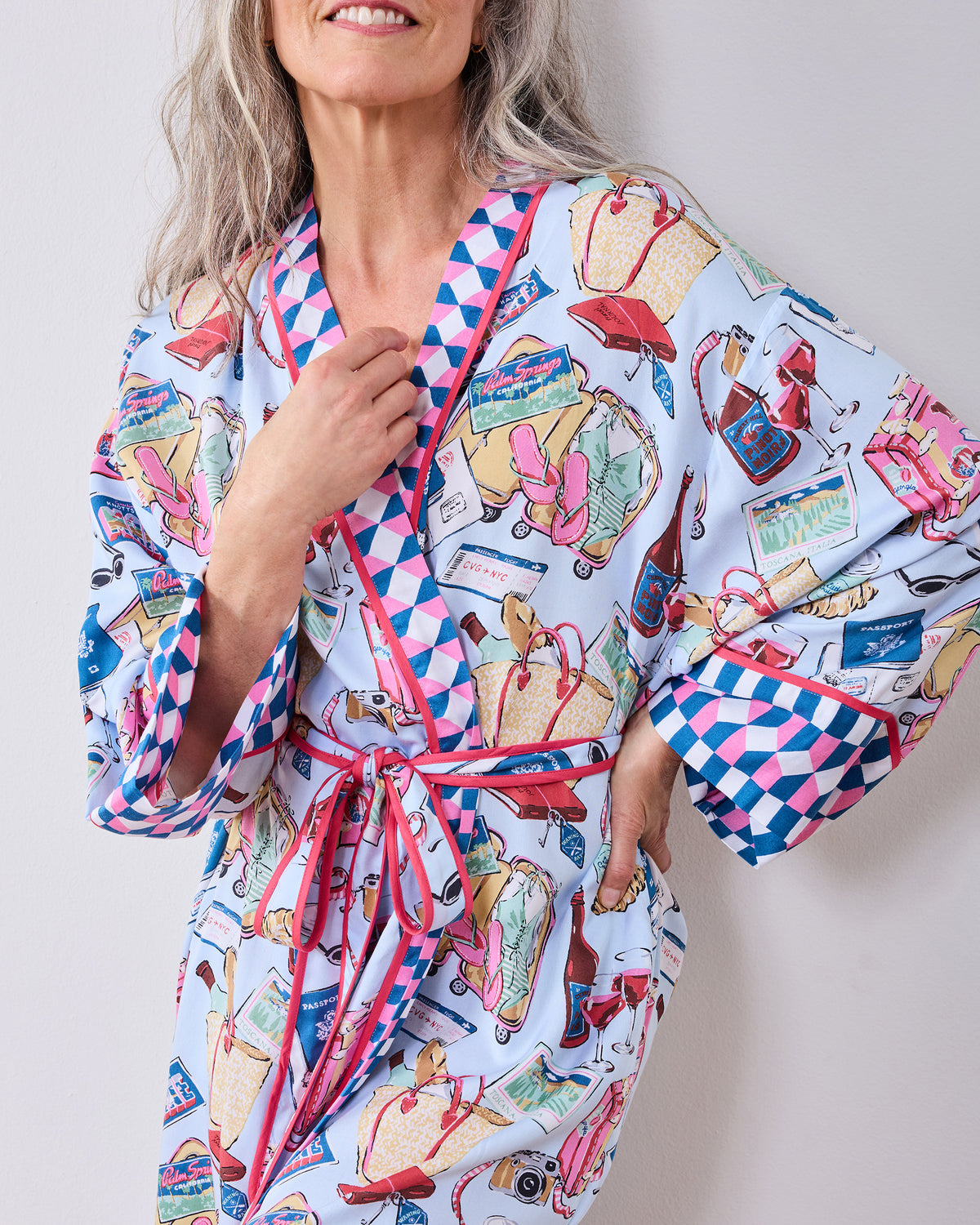 Close-up of the Emotional Baggage printed robe showing the wrap front, waist ties, pocket, and contrasting cuff.