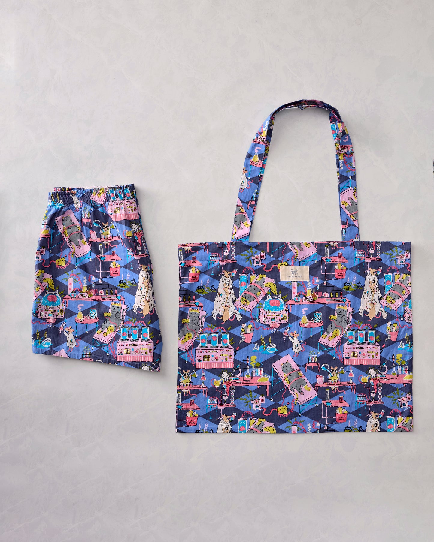 Checkered Sapphire It's Alive bundle showing patterned boyfriend boxers beside a matching tote bag.