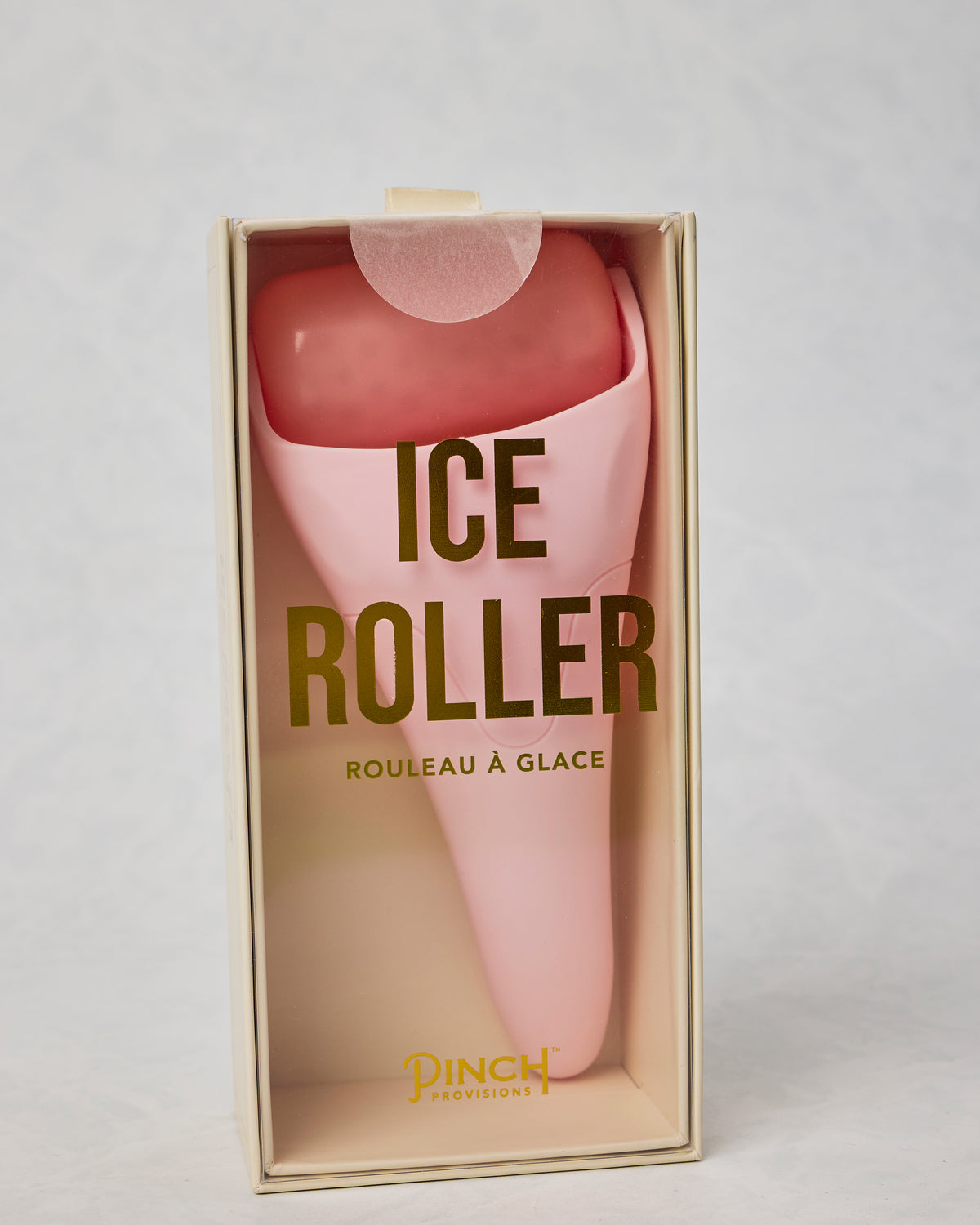 Pink ice roller in an open presentation box labeled “ICE ROLLER” and “ROULEAU À GLACE.”