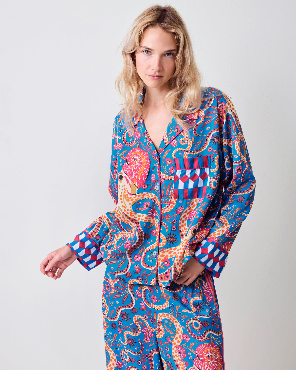 Model wearing the blue Octopus Isle pajama top and wide-leg pants, shown from the front with patterned cuffs and chest pocket