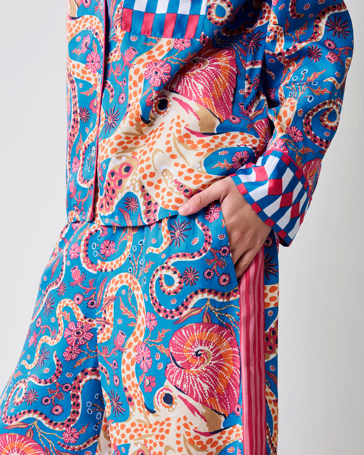 Close-up of the Octopus Isle pajama top and pants showing the octopus print, chest pocket, cuff, and side pocket