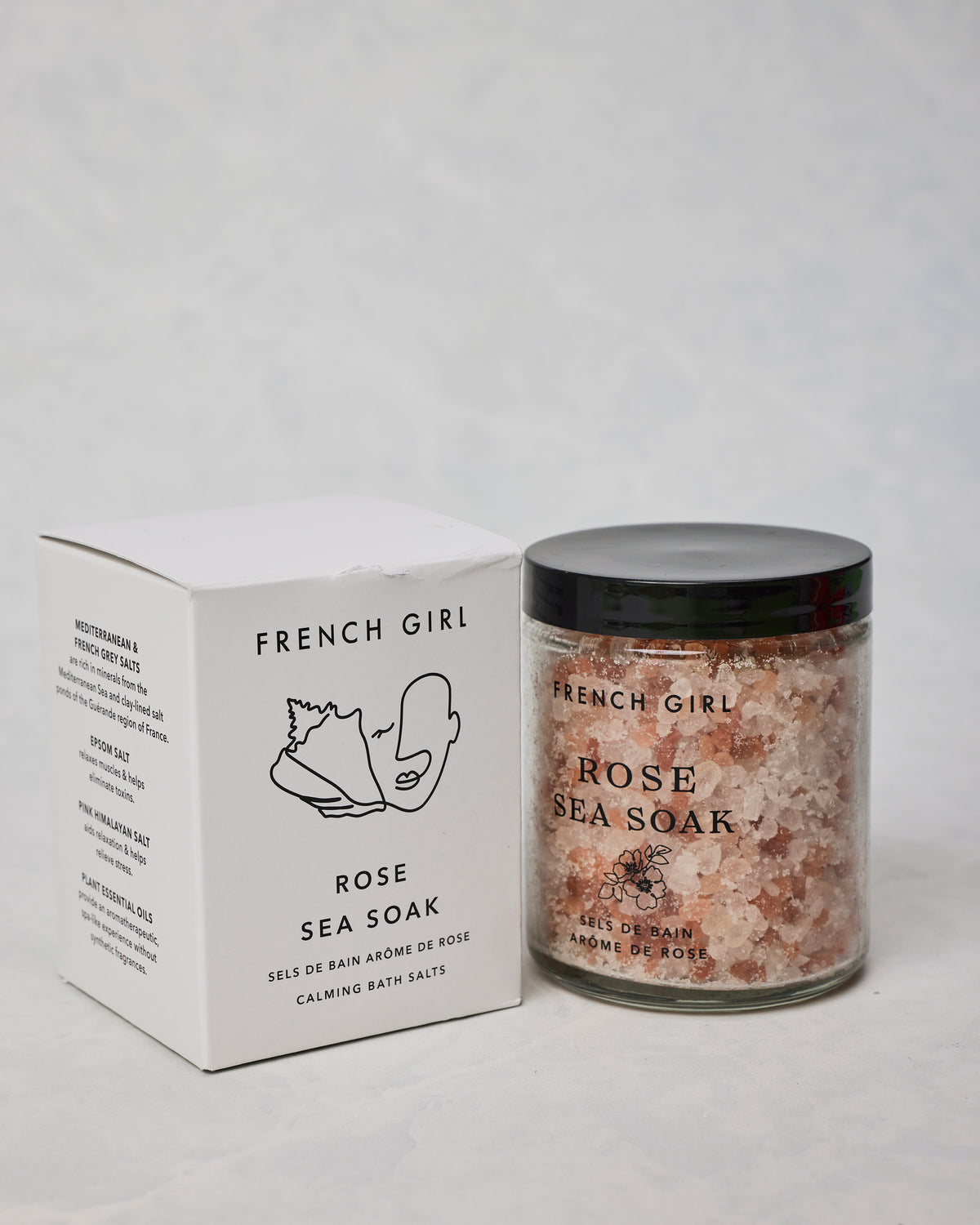 French Girl Rose Sea Soak shown in a labeled jar beside its box, with pink and white bath salts visible through the jar.