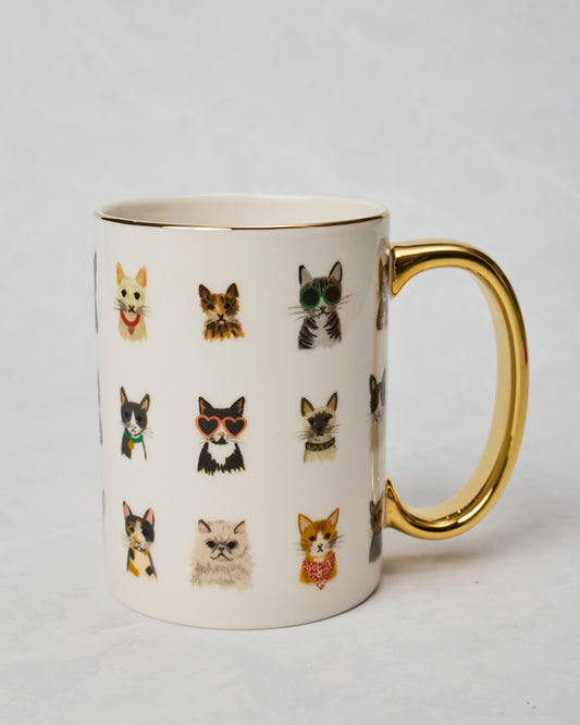 Cool Cats porcelain mug shown from the opposite side with a gold handle and rows of illustrated cats, including cats wearing sunglasses.