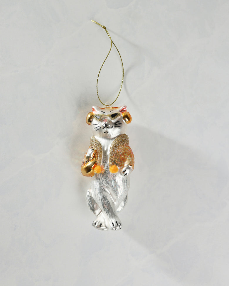 Front view of a silver-and-gold cat ornament with a hanging cord, glittered clothing, and crossed lower body.