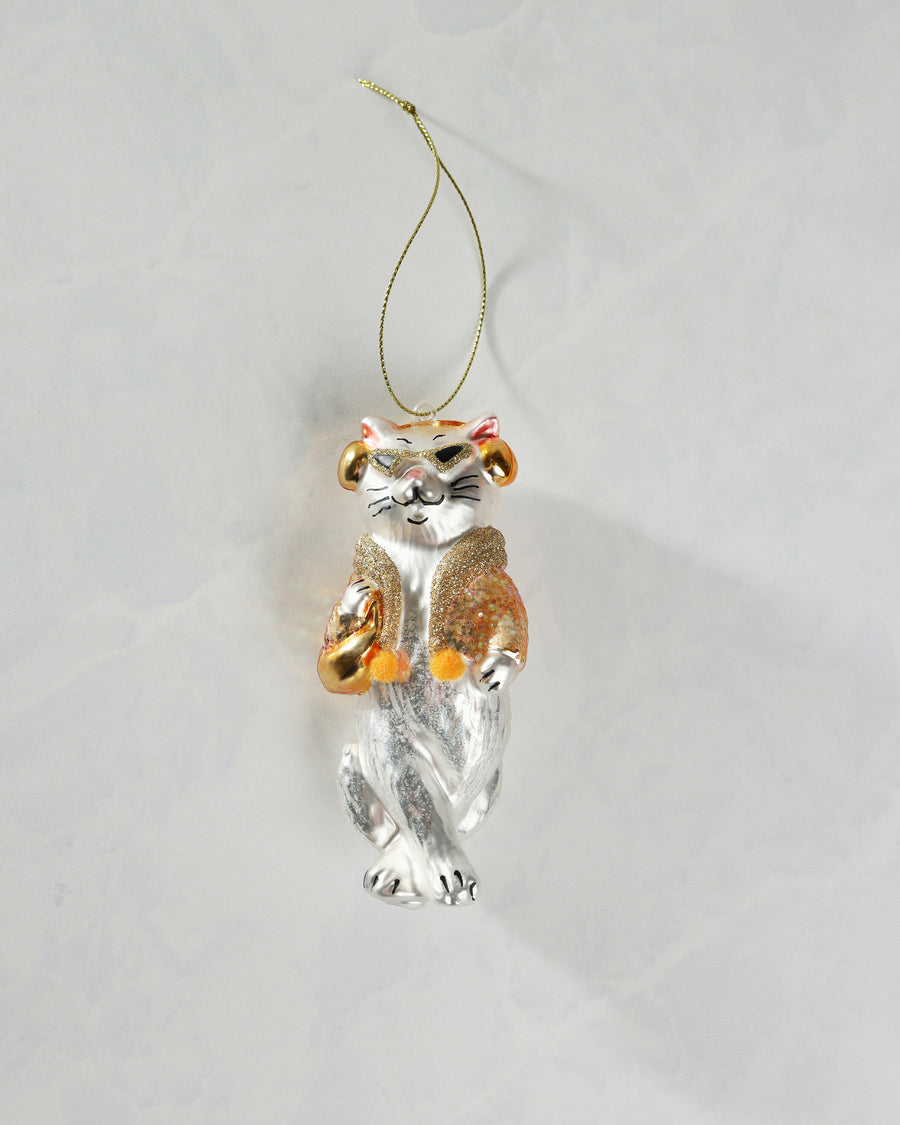 Front view of a silver-and-gold cat ornament with a hanging cord, glittered clothing, and crossed lower body.