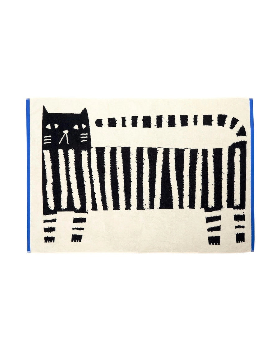 Flat-lay view of the Lazy Cat XL sheet towel, featuring a black cat and piano-key pattern on a light background.