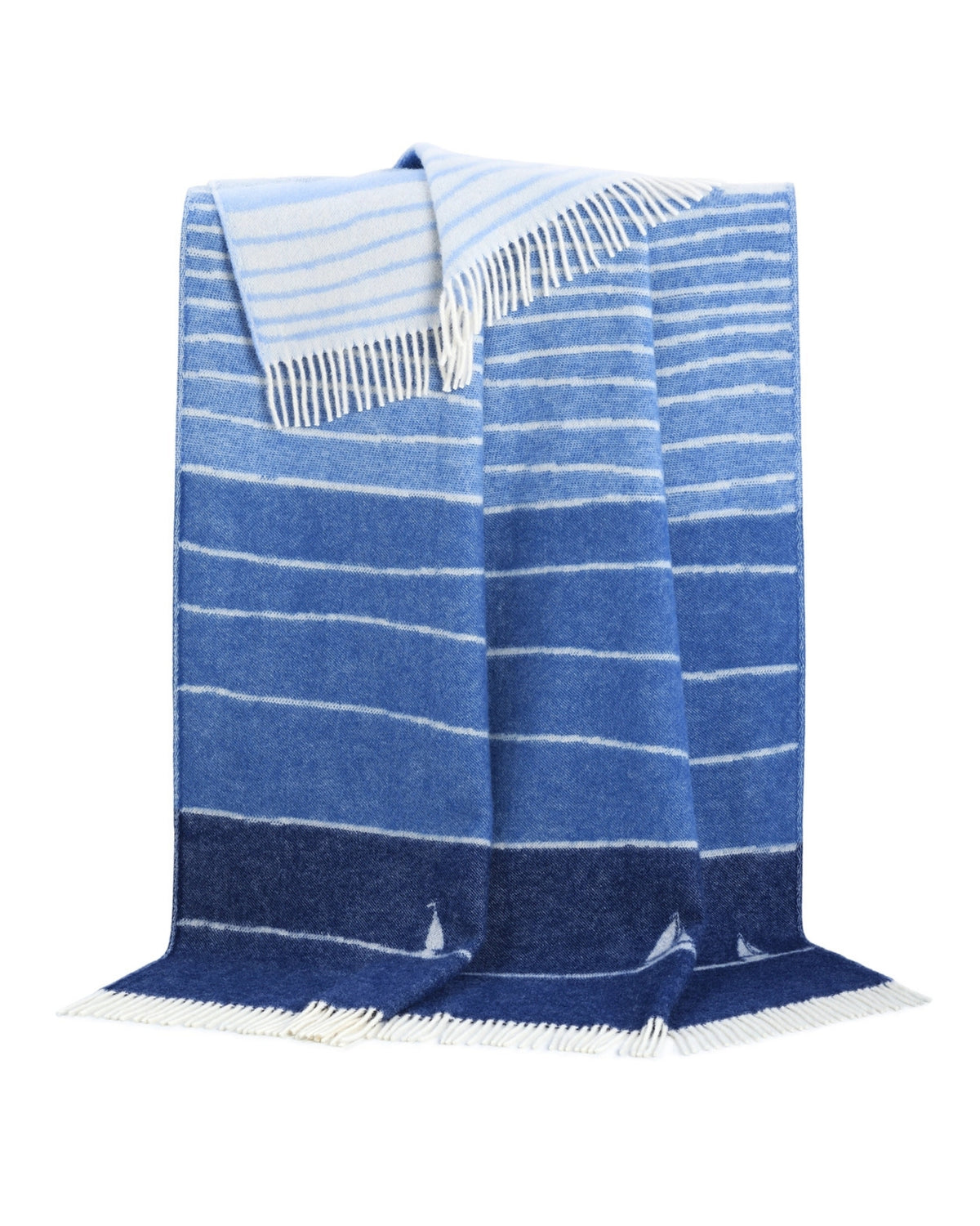 Boat wool throw draped to show blue-and-white horizontal stripes, sailboat motifs, and fringed edges.