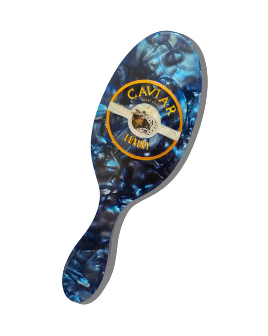 Blue marbled handheld hair brush with a gray edge and circular Solar Eclipse design