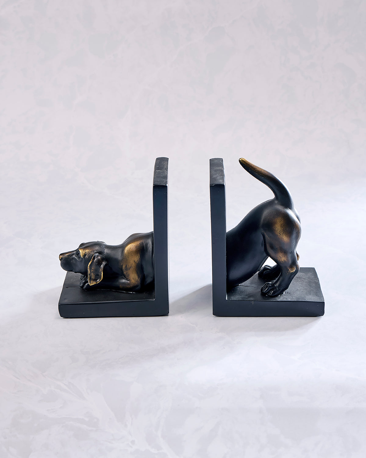 Pair of bronze-finish Labrador dog bookends shown from the side, with one dog lying down and the other standing with its tail raised.