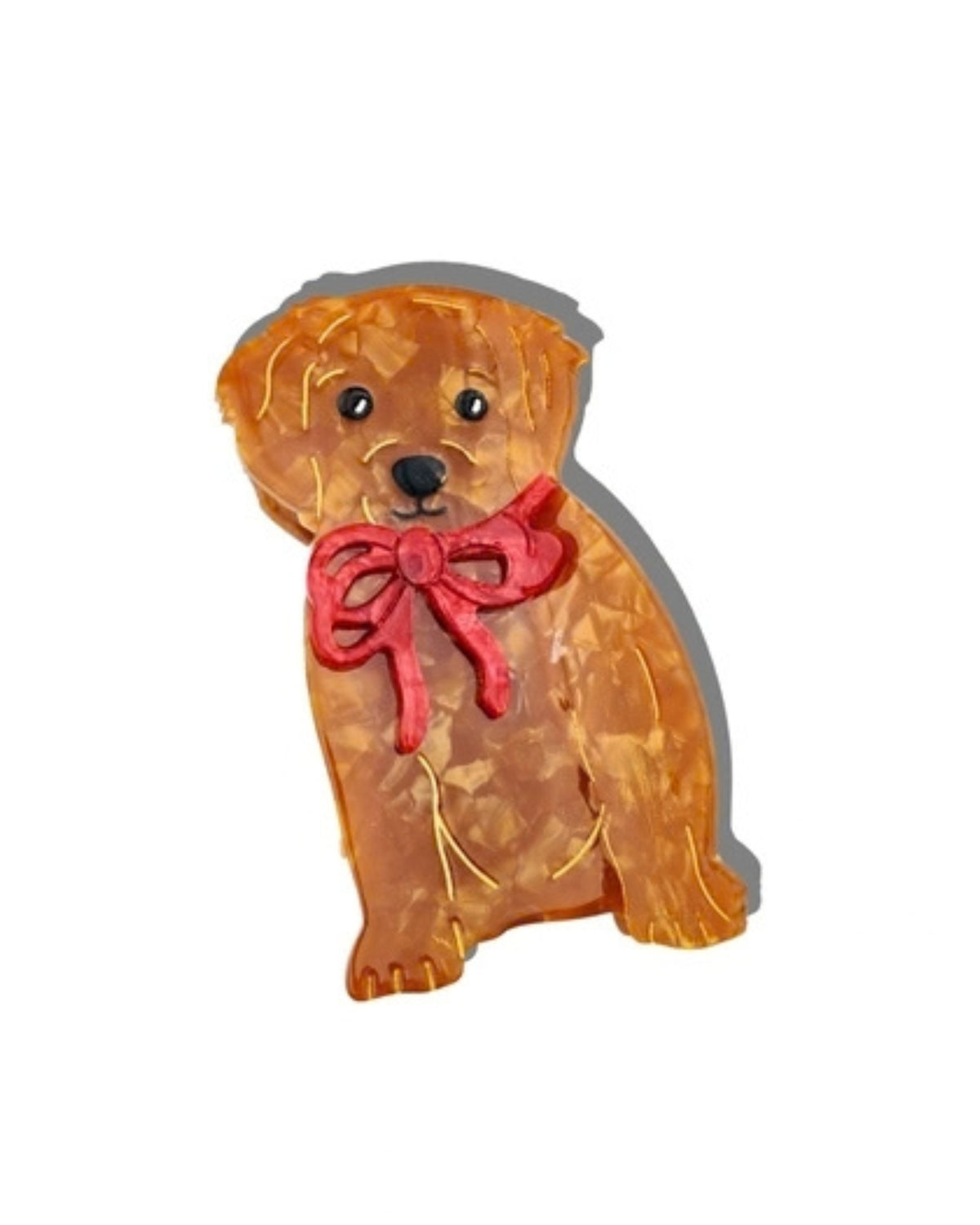 Front view of a brown puppy-shaped hair claw clip with a red bow.